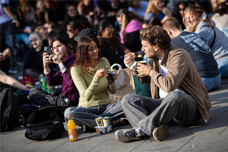 Neuer Internet-Trend:  Menschen treffen sich in Hannover, einem Platz in Hannover, um Pudding mit Gabeln zu essen. Moritz Frankenberg/dpa