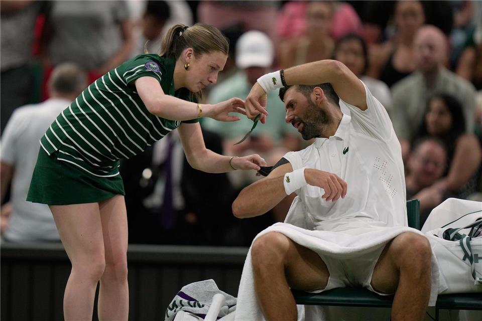 Novak Djokovic ließ sich von einem Ballmädchen helfen - und erschreckte sie für einen ganz kurzen Moment.Brian Inganga/AP/dpa