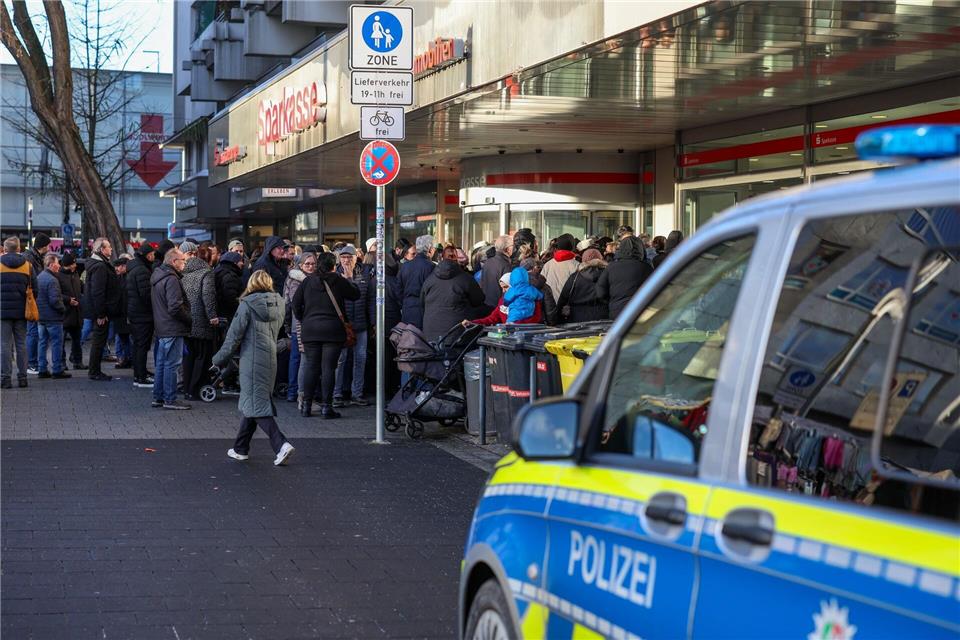 Polizisten sichern den Eingang der Sparkassenfiliale in Gelsenkirchen-Buer, nachdem wartende Kunden versucht hatten in die Bank zu gelangen.Christoph Reichwein/dpa