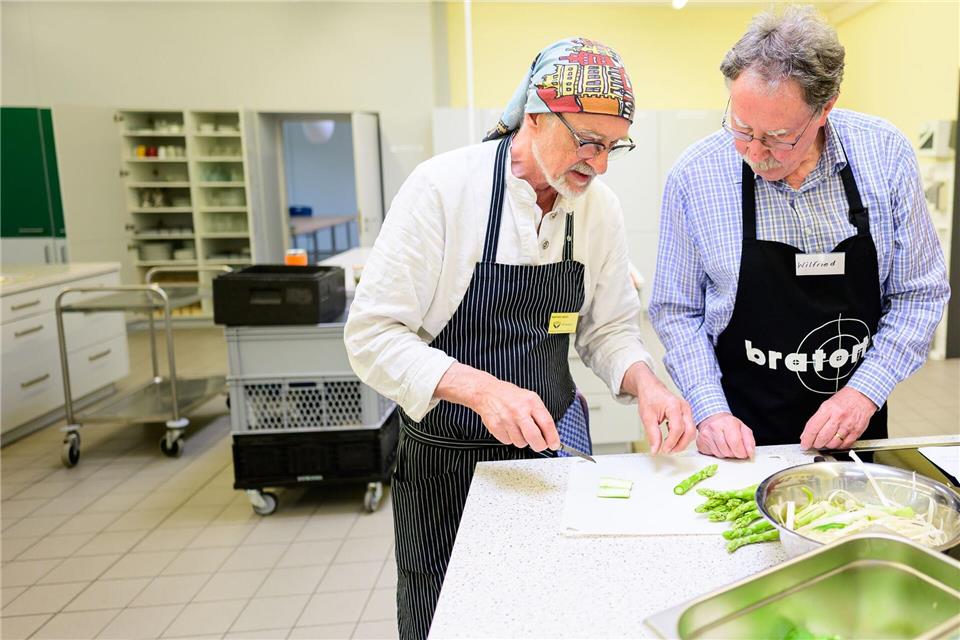 Profikoch Winfried Marx leitet einen Witwer beim Kochen an.  Philipp Schulze/dpa