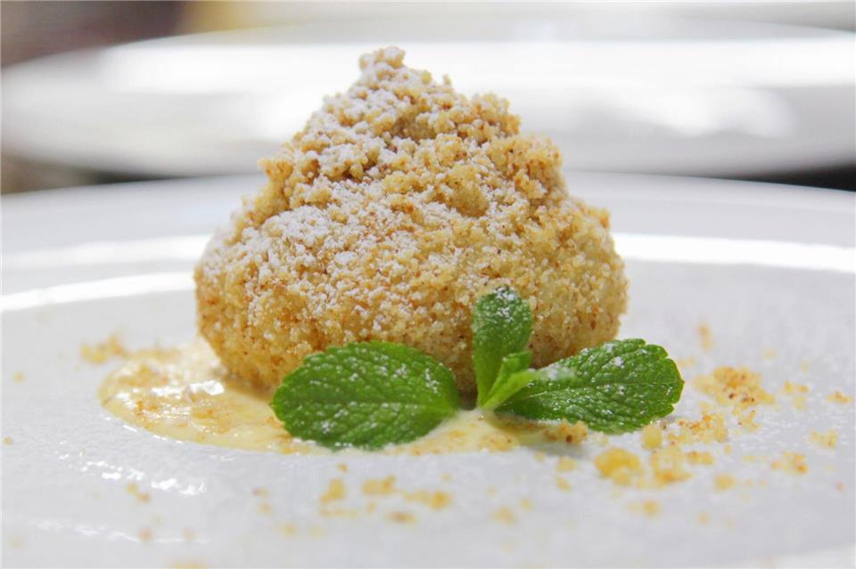 Puderzucker, süße Streusel - und drinnen die Sommerfrucht: Marillenknödel sind eine Genießer-Süßspeise.Beate Wöllstein/Wöllsteins Desserthaus/dpa-tmn