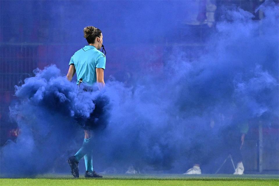 Schiedsrichterin Olatz Rivero Olmedo trägt den blauen Rauchtopf vom Spielfeld.Sven Hoppe/dpa