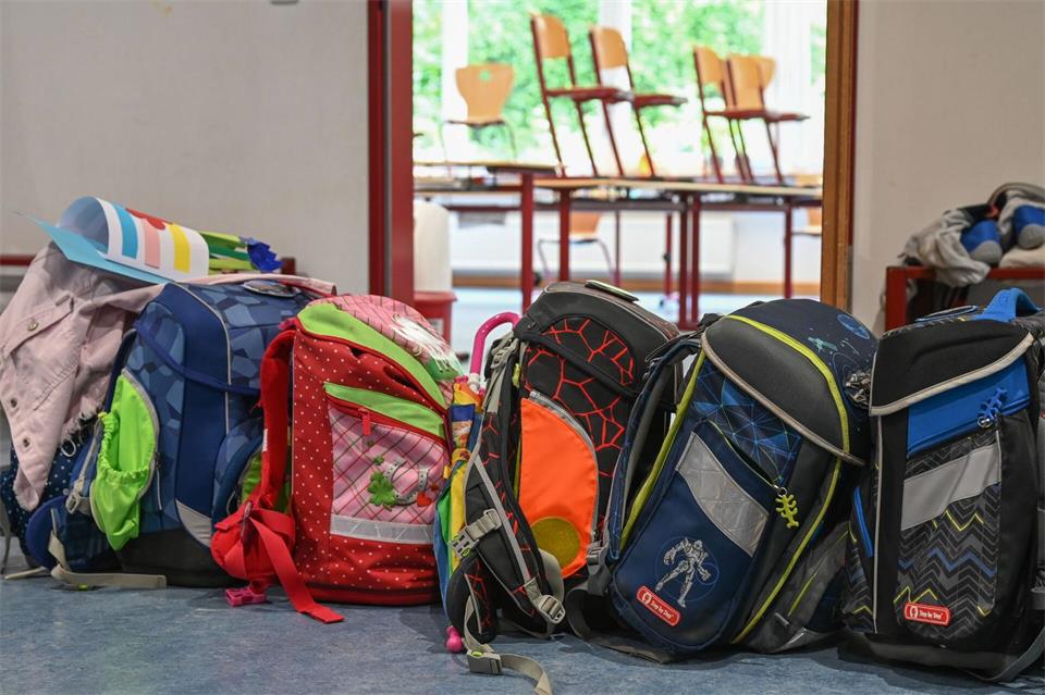 Schulranzen, Sportzeug, Sonnenschutz, Brotzeit - gerade am Anfang schafft der Nachwuchs es nicht ohne Hilfe. (Symbolbild).Arne Dedert/dpa