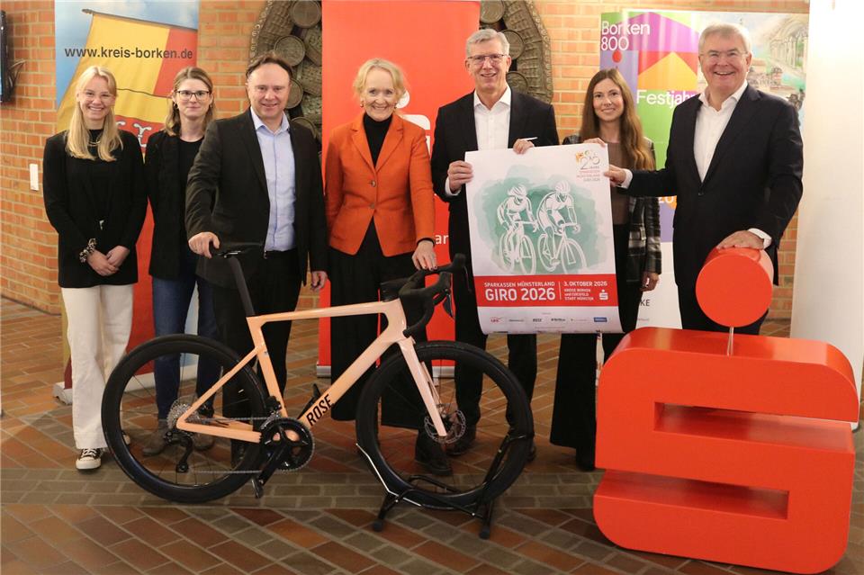 Sie werben für den Sparkassen Westmünsterland Giro 2026, der in Borken starten wird (von links): Carolin Fröchte und Jana Mathmann (beide Sportamt der Stadt Münster), Landrat Dr. Kai Zwicker, Borkens Bürgermeisterin Mechtild Schulze Hessing, Norbert Hypki (Vorstandsvorsitzender der Sparkasse Westmünsterland), Nina-Teresa Leson (Leiterin des Sparkasse-Westmünsterland-Beratungscenters Borken und selbst Teilnehmerin) sowie Jürgen Büngeler (stellvertretender Vorstandsvorsitzender der Sparkasse Westmünsterland).