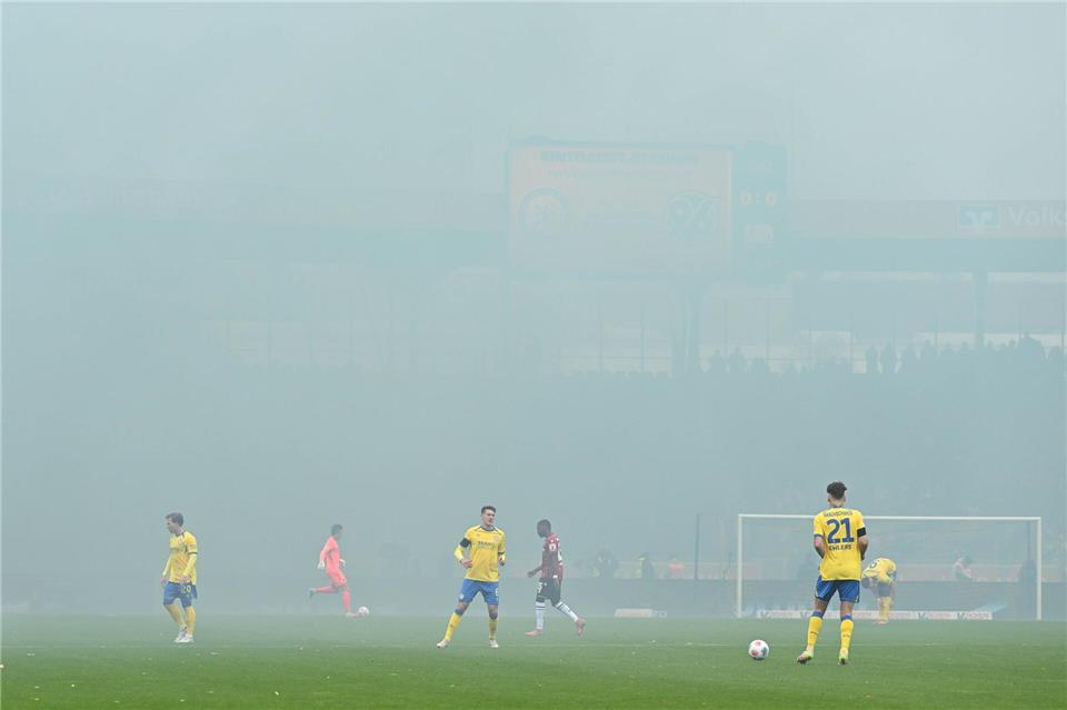 Rot nach Würgegeste: Hannover gewinnt hitziges Derby  Spieler im Nebel: Das Derby zwischen Eintracht Braunschweig und Hannover 96 wird nach dem Abbrennen von Pyrotechnik im Hannover-Fanblock kurz unterbrochen.Swen Pförtner/dpa
