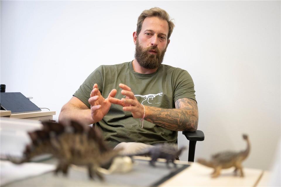 T-Shirt, Tattoos, Figuren auf dem Schreibtisch - Marco Schade ist seine Passion für Dinosaurier leicht anzusehen.Philip Dulian/dpa