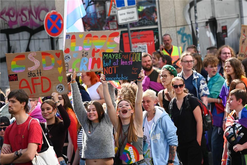 Teilnehmende tragen selbst gestaltete Plakate und Schilder.Heiko Rebsch/dpa
