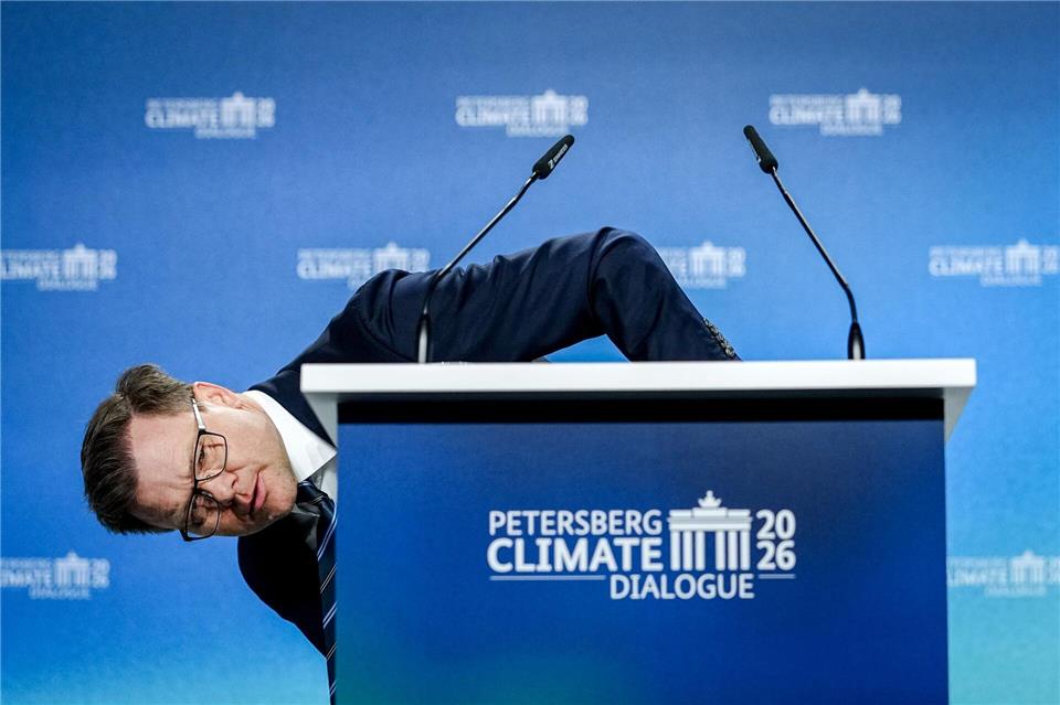 Umweltminister Carsten Schneider (SPD) beugt sich beim 17. Petersberger Klimadialog neben das Pult.Kay Nietfeld/dpa