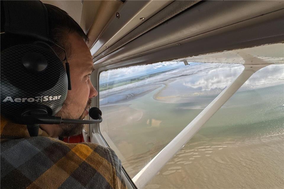 Wissenschaftler Ole Stejskal hält Ausschau nach Seehunden auf Sandbänken. Lennart Stock/dpa